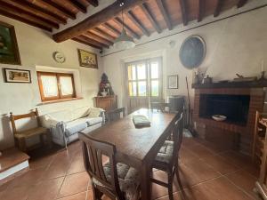 a living room with a wooden table and a couch at Podere Boschetto Moroni in Massa Marittima
