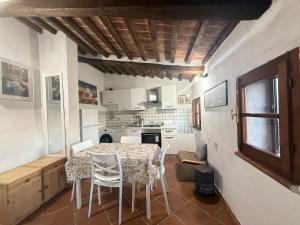 a kitchen with a table and chairs in a room at Podere Boschetto Moroni in Massa Marittima