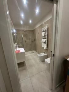 a bathroom with a shower and a toilet and a sink at Souad 2 in San Prisco