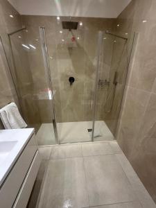 a shower with a glass door in a bathroom at Souad 2 in San Prisco