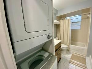 a bathroom with a washing machine and a toilet at Beautiful Days in Orange Park +50 photos
