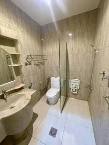 a bathroom with a toilet and a sink and a shower at Quiet Rooms 8 Serviced Apartments in Riyadh +15 photos