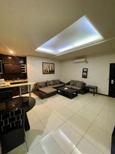 a living room with a couch and a table at Quiet Rooms 8 Serviced Apartments in Riyadh