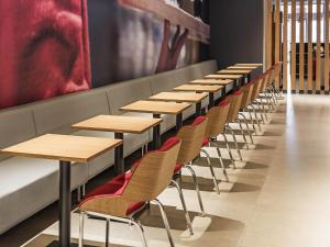 una fila di tavoli e sedie in una stanza di ibis Chapeco a Chapecó