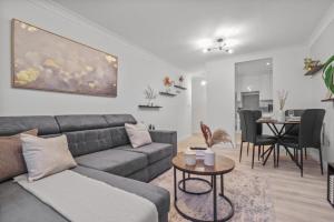 a living room with a couch and a table at Modern 2 Bed Apartment, Secure Parking, Central in Hemel Hempstead +15 photos