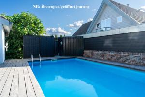 a swimming pool in the backyard of a house at Idyllic living near Svendborg in Svendborg +6 photos