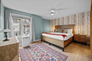 a bedroom with a bed and a window at 2 Bedroom Condo Banff, Canmore sleeps 6 comfortably in Canmore