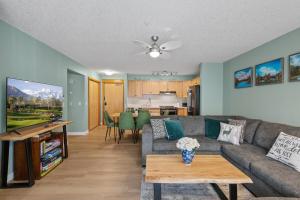a living room with a couch and a table at 2 Bedroom Condo Banff, Canmore sleeps 6 comfortably in Canmore