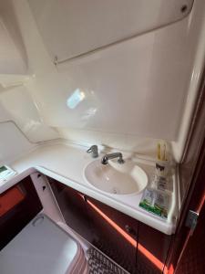 a bathroom with a sink in an airplane at Barco Marina de Cascais in Cascais +3 photos