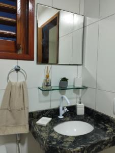 a bathroom with a sink and a mirror at Casa Mari Suites in Canoa Quebrada +65 photos