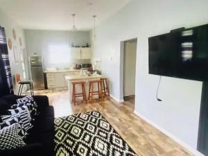 a living room with a couch and a kitchen at Mayaro getaway in Saint Margaret