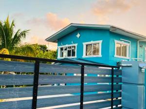 a blue house on the beach with a fence at Mayaro getaway in Saint Margaret
