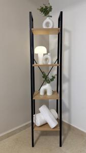 a shelf with towels and vases in a room at Ramon Palms in Mitzpe Ramon