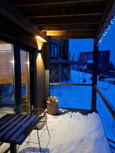 a patio with a table and chairs on a balcony at Shepit space in Slavske