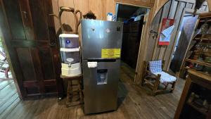 a kitchen with a refrigerator and a coffee maker at Landscape-Cabaña winter full equipada in La Cruz