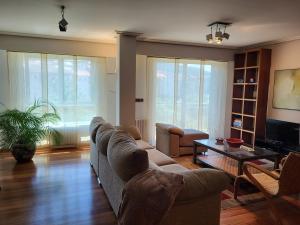a living room with a couch and a table at O lar da luz in Ourense