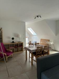 a living room with a table and a couch at MP Apartments in Hückelhoven