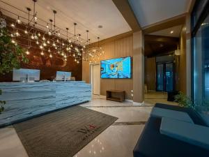 a lobby with a large screen in a building at Wellborn Hotel Limited in Lekki
