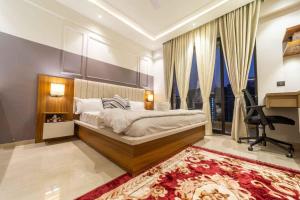 a bedroom with a bed and a desk in a room at Celestia Grand in Lucknow