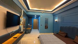 a living room with a flat screen tv and a couch at Celestia Grand in Lucknow
