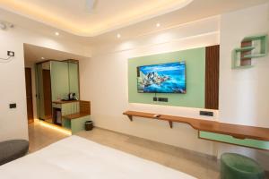 a hotel room with a bed and a mirror at Celestia Grand in Lucknow