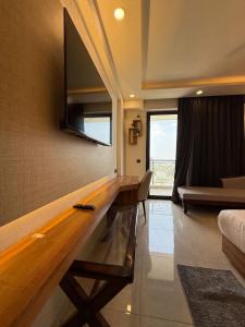 a room with a large wooden counter with a television on the wall at Celestia Grand in Lucknow +3 photos