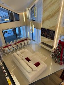 a living room with a white couch and a fireplace at Sadova Loft View in Sadova