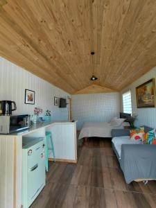 a room with a couch and a bed in a room at Tiny House Aeropuerto el Tepual in Puerto Montt