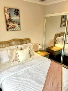 a bedroom with a bed and a large mirror at Beach Road Bliss- Whitsundays in Cannonvale +25 photos