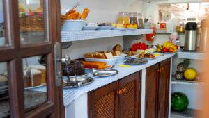 a kitchen with a bunch of food on a counter at Pousada do Rei in Ubatuba