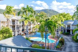 a view of a resort with a pool and palm trees at Beach Road Bliss- Whitsundays in Cannonvale