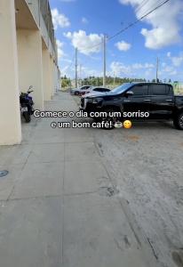 a truck parked next to a building with a motorcycle at POUSADA DEUS É FIEL Coruripe in Coruripe