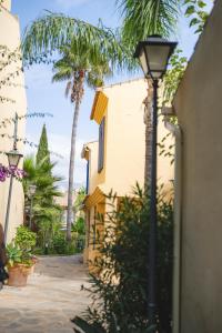 een straatlicht naast een gebouw met palmbomen bij New - MiJa basement Loft Apartment steps from Beach - perfect for Sun and Sport Seekers in Marbella