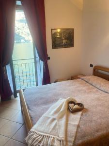 a bedroom with a bed with a heart towel on it at La casa di Mimo in Nesso