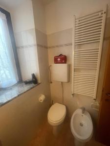 a small bathroom with a toilet and a sink at La casa di Mimo in Nesso +19 photos