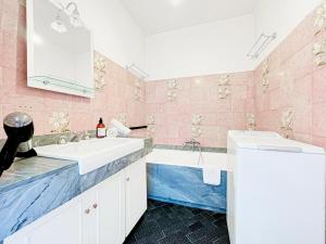 a pink bathroom with a sink and a tub at Cannes Montfleury - Comfortable accommodation Center in Cannes +32 photos
