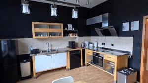 a kitchen with black walls and white appliances at Room 4 - shared house in Linz am Rhein
