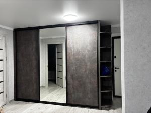 a large mirror in a room with a closet at New apartment Căușeni in Căuşeni