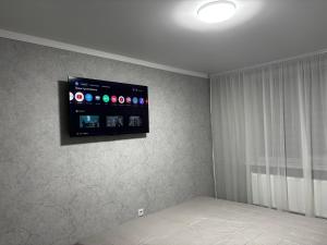 a flat screen tv on the wall of a bedroom at New apartment Căușeni in Căuşeni