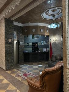 a lobby with a bar with a man sitting at a desk at Darna Boutique Hôtel- Newly Renovated in Rabat