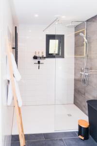 a bathroom with a shower with a glass door at Chalet met hottub in Putten