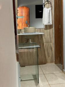 a bathroom with a sink and a mirror at Pousada Hibiscos in Serra do Cipo +14 photos