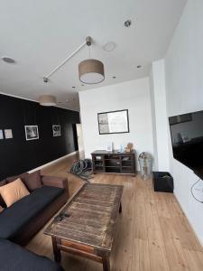 a living room with a couch and a table at DoubleRoom shared house 1 floor in Linz am Rhein