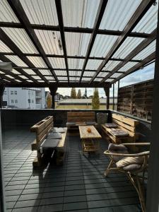 a patio with benches and tables on a roof at DoubleRoom shared house 1 floor in Linz am Rhein