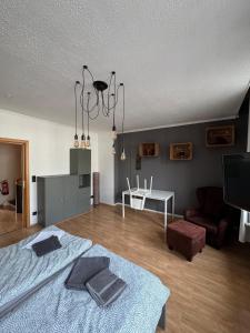 a bedroom with a bed and a living room at DoubleRoom shared house 1 floor in Linz am Rhein