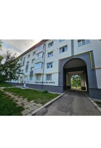 a large building with a tunnel in front of it at AchiDav 135 in Onești