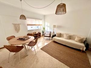 a living room with a couch and a table at Miguel Surf House in Costa da Caparica