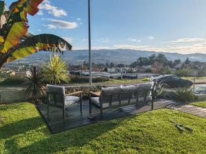 two chairs sitting on a deck with a view of a city at Vila do Sol in Figueiredo
