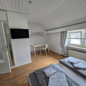a bedroom with a bed and a table in it at DoubleRoom - work and stay - shared house - 2floor in Linz am Rhein