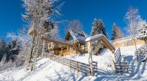 a log cabin in the snow at Black Roof in Arada